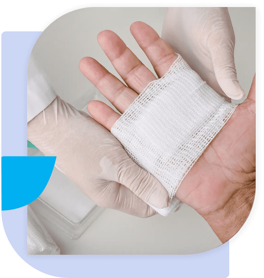 A person with gloves on and one hand holding something.